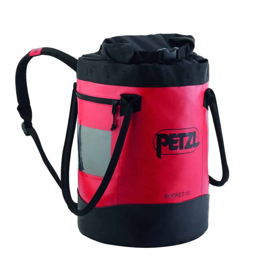 A red and black Petzl Bucket bag, perfect for industrial rescue, with a cylindrical shape, shoulder straps, a zippered pocket, and the Petzl logo.
