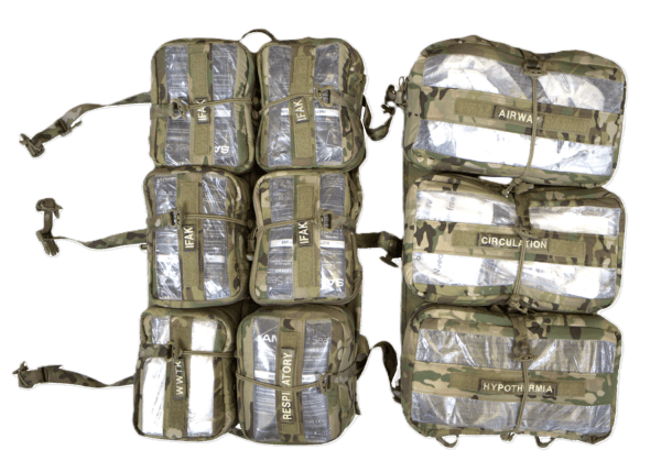 Eight camouflage medical kits, labeled 