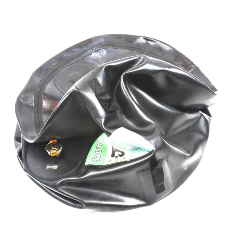 Deflated black inflatable object with an air valve, perfect for tactical rescue training, featuring a transparent pocket holding packaging.